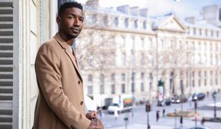 Uncorked Mamoudou Athie on a balcony in Paris