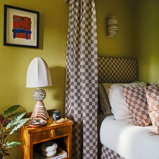 Green bedroom with brown check curtains and headboard