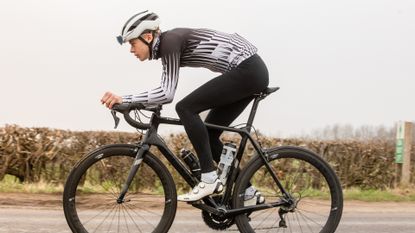 Image shows a person who is cycling with knee pain
