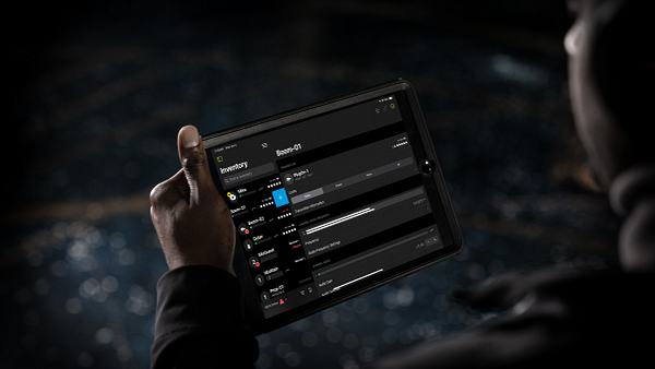 A man using Shure&#039;s Wireless Workbench on an iPad tablet. 