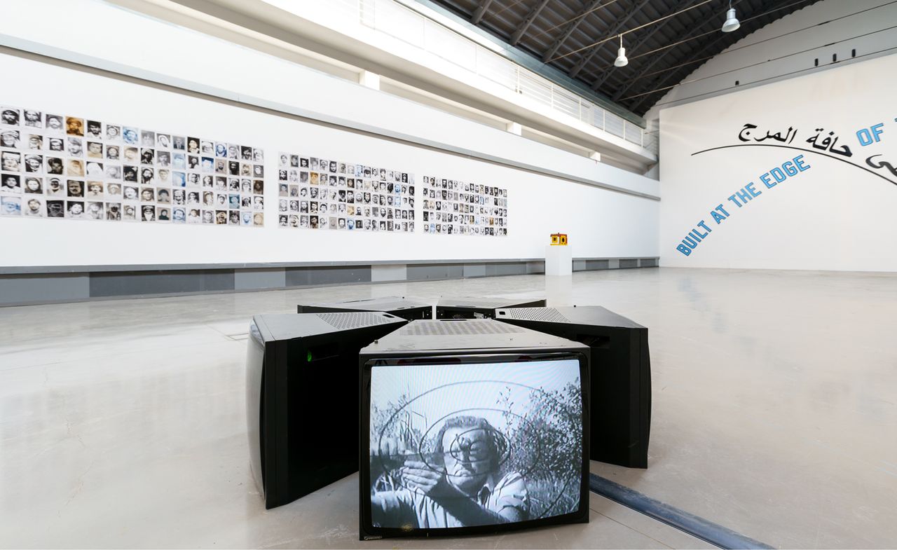 Installation view of &#039;L&#039;altro, lo stesso&#039; at ZACentrale. Back: Lida Abdul, Time, Love and the Workings of Anti-Love, 2013, Courtesy the artist; Fondazione Merz; Lawrence Weiner, Built at the edge of the grass, 2007, Courtesy the artist; Galleria Giorgio P