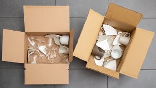 Broken ceramics and glass in two boxes