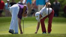 Players picking up ball markers