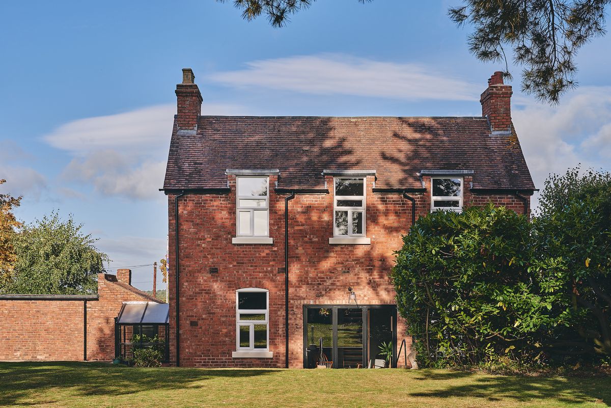 brick Victorian house with bifold doors and garden