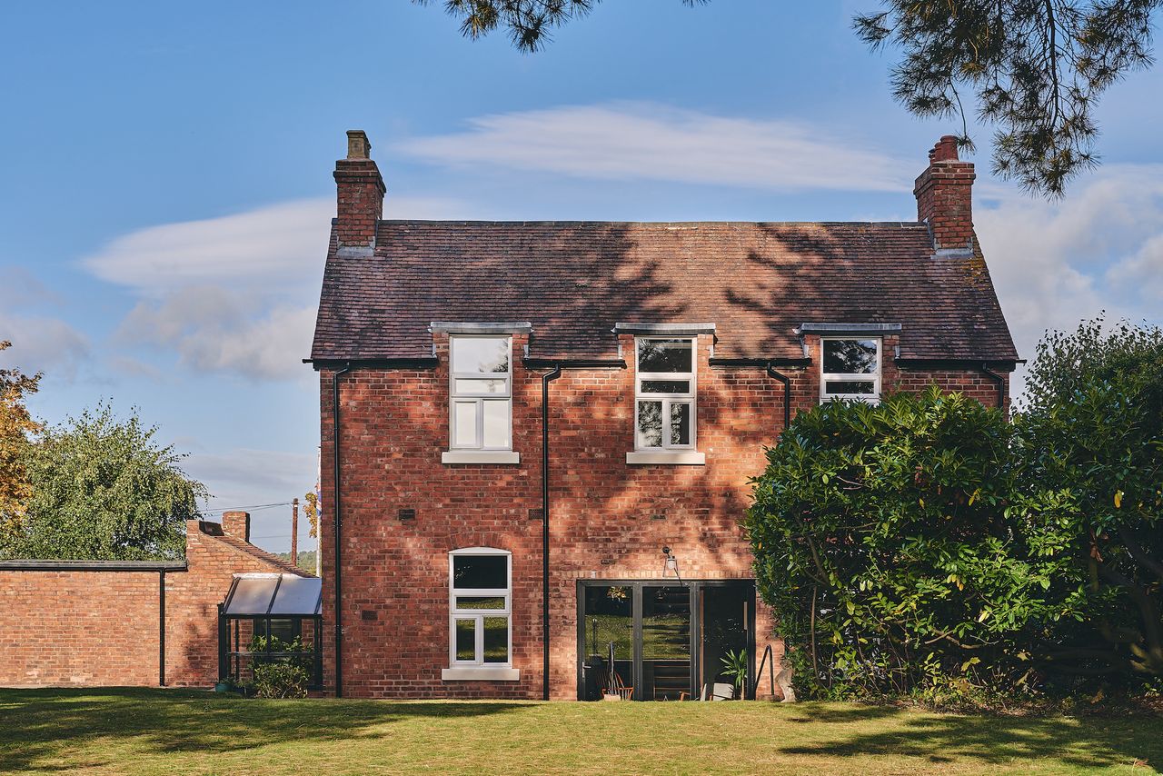 brick Victorian house with bifold doors and garden