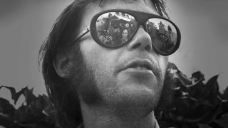 Neil Young wearing reflective sunglasses