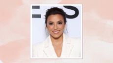 Image of Eva Longoria smiling with brunette undone updo and wearing a white blazer, on a pink watercolour background