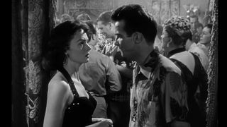 Montgomery Clift and Donna Reed talk in a crowded bar in From Here to Eternity