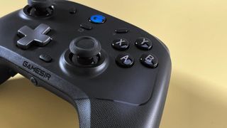 The GameSir T4 Cyclone Pro game controller for iOS and macOS against a yellow background.