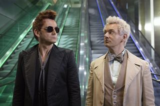 MICHAEL SHEEN and DAVID TENNANT iat the bottom of an escalator in a still from good omens