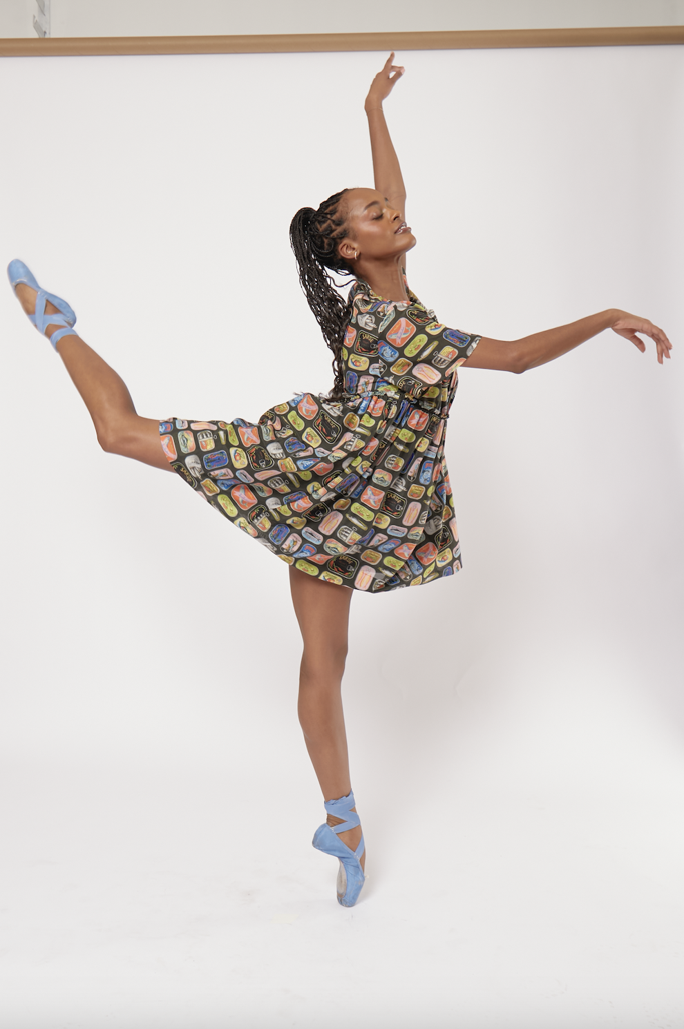 a ballerina wearing a dress covered in sardine tins