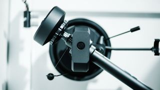 Pro-Ject turntable tonearm close-up showing the couterweight