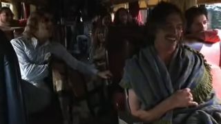 The cast of Almost Famous sing on a bus