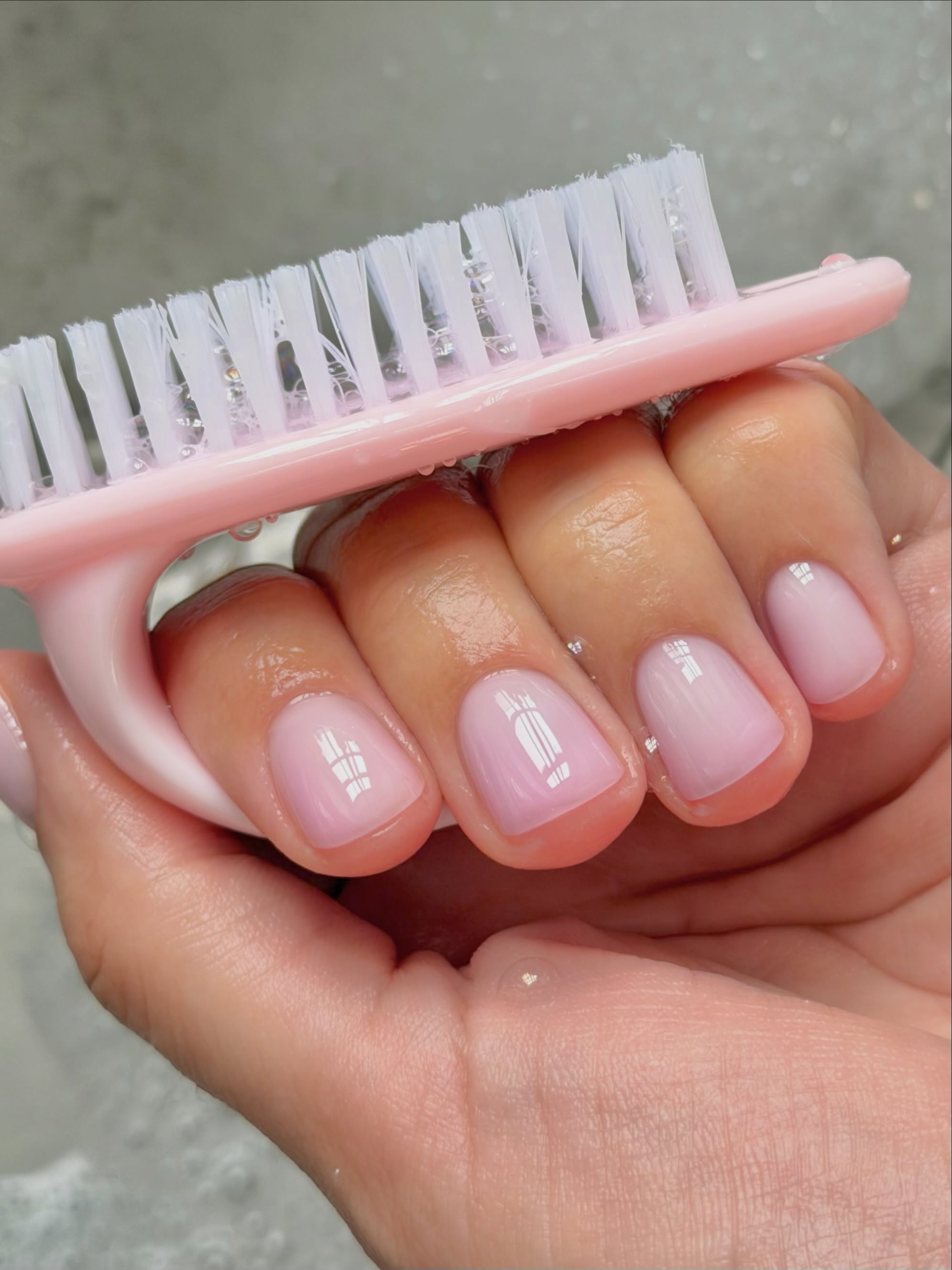 Sheer pink manicure.