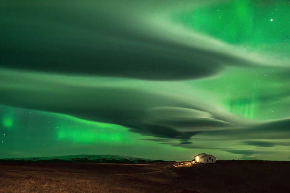 The auroras are best seen during the winter, when nights are long. Hours of patience by photographer Daniele Boffelli resulted in this image that captures both clouds and auroras in the night sky.