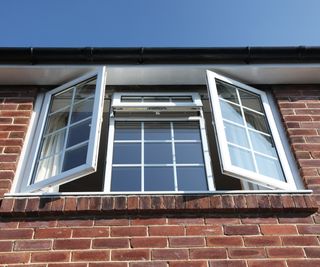 doubled glazed uPVC window on top floor of brick house