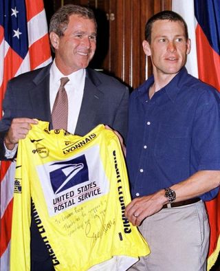 Then-Texas governor George W. Bush is presented with a yellow jersey by Lance Armstrong in 1999