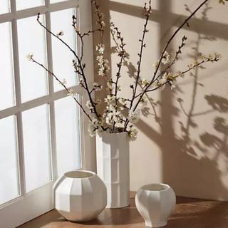 Three white vases in a corner