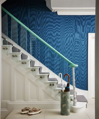 hallway with white wooden stairs modernised with glass spindles and green handrail