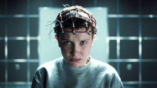 Eleven cries with a crown of probes stuck on her head