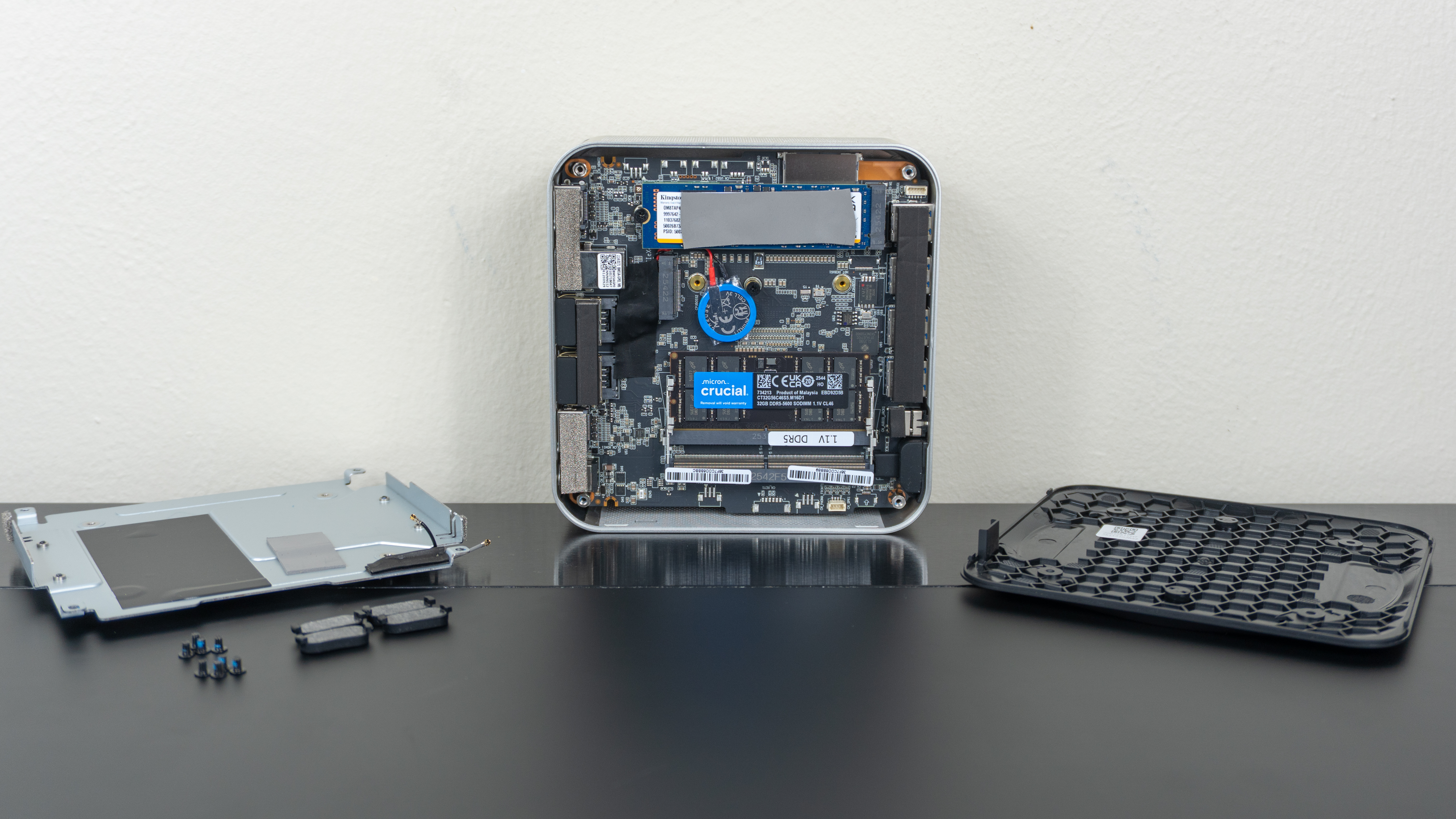 The Geekom A9 Max 2026 Edition open on a table with all the parts laid out next to it