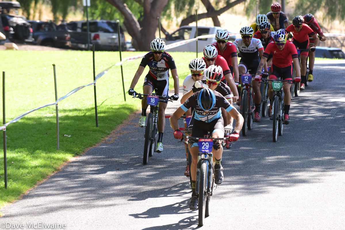 Fernando Paez (Raleigh Clement) leading a large group on the pavement.
