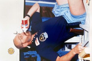 STS-51F payload specialist Loren Acton evaluates a Pepsi space soda can aboard space shuttle Challenger in 1985.