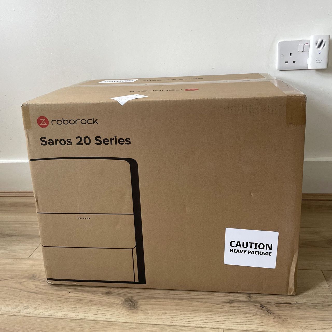 Roborock Saros 20 Robot Vacuum box sitting on wood-effect flooring