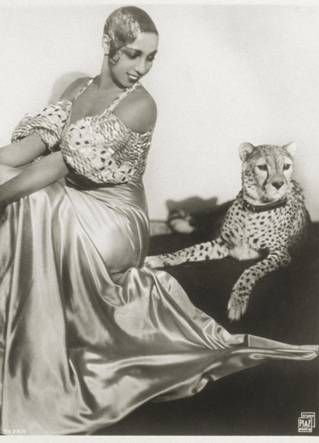 A black and white photograph of Josephine Baker and her pet cheetah