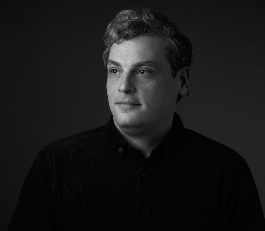 black and white headshot of Adam Sexton