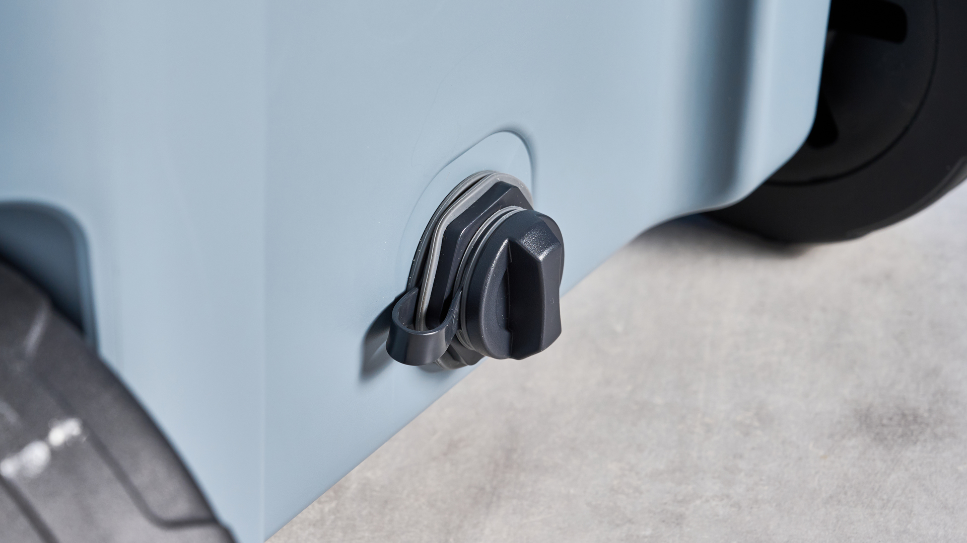 The water spout of the Ninja FrostVault 45QT Wheeled Cooler photographed in front of a blue background.