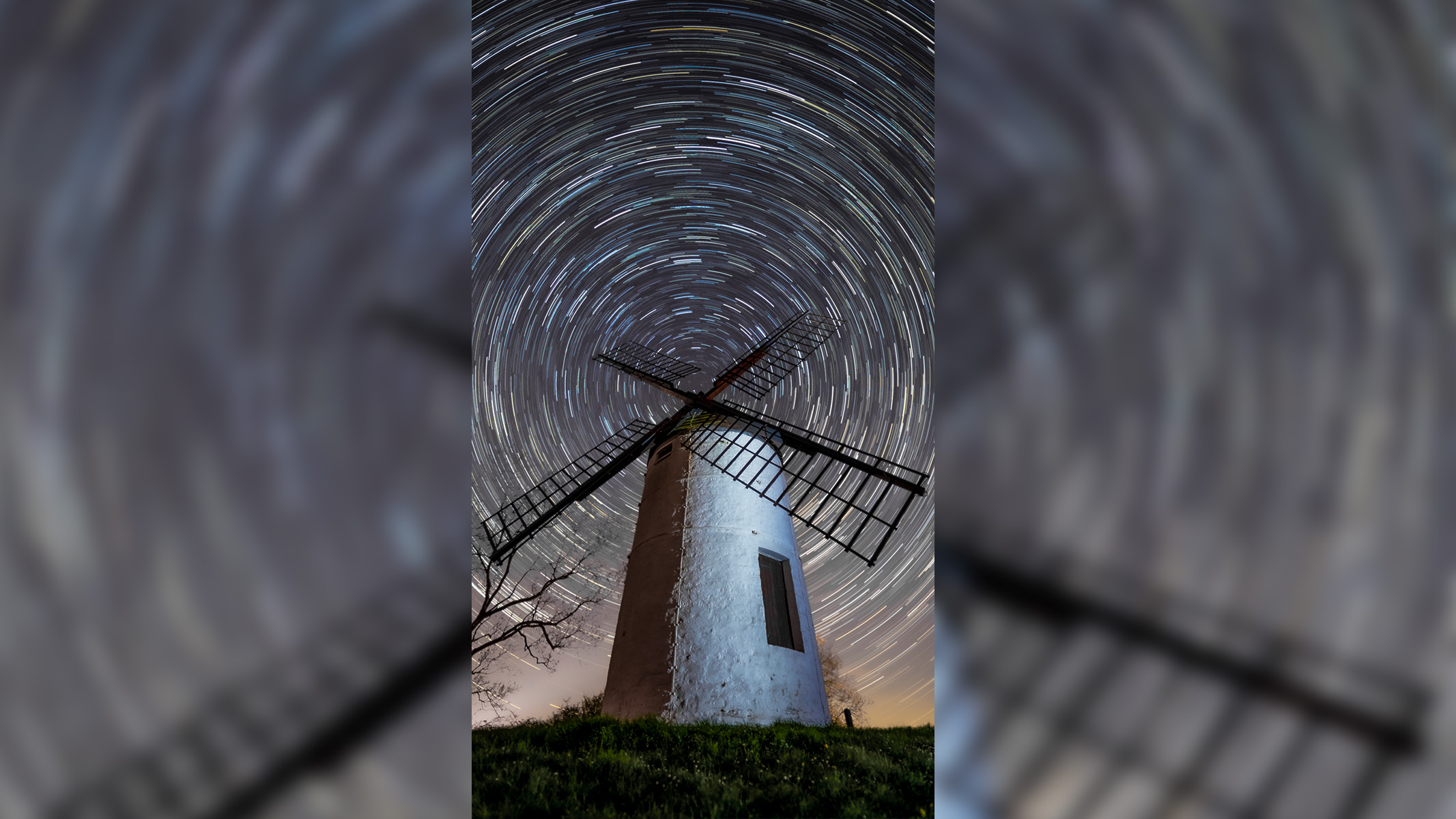 Ashton Windmill in the UK, with a circular star trail in the background