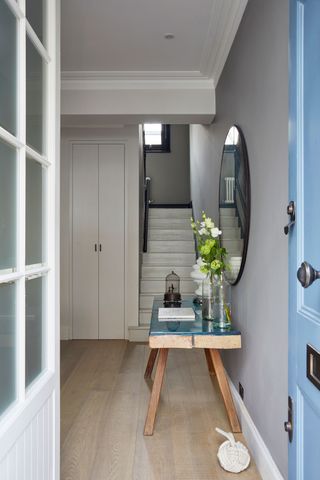 Hallway with open blue front door
