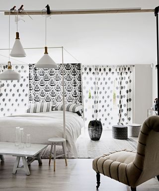 White bedroom with large lighting fixture