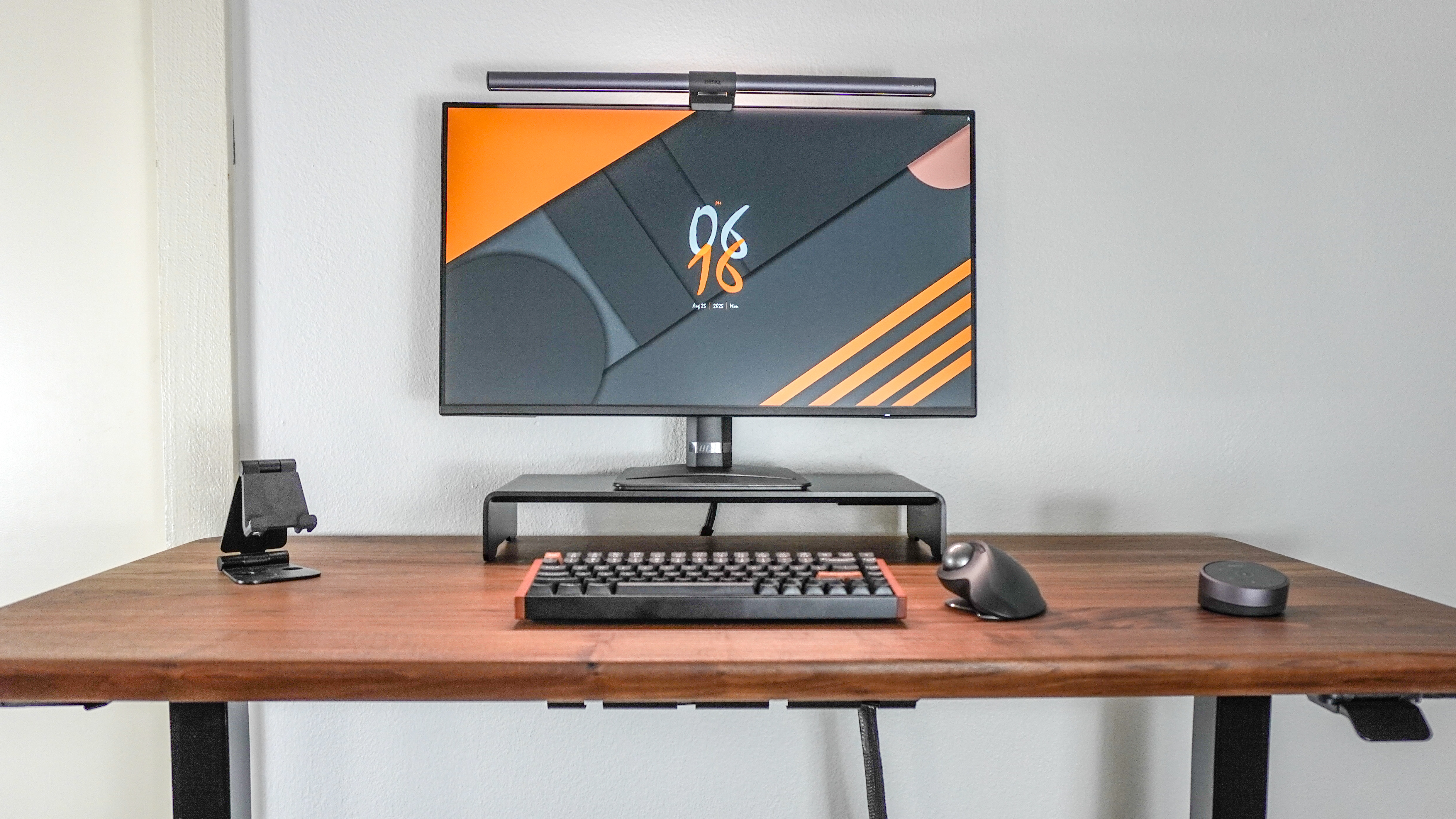A simple, single monitor desk setup built around the MSI Cubi NUC AI+ 2MG with the mini PC mounted on the back of the display