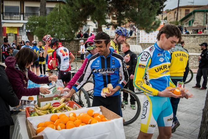 Riders enjoy some food after the stage