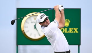 Corey Conners hits a tee shot with a driver