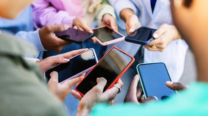 Group of young people using different phones
