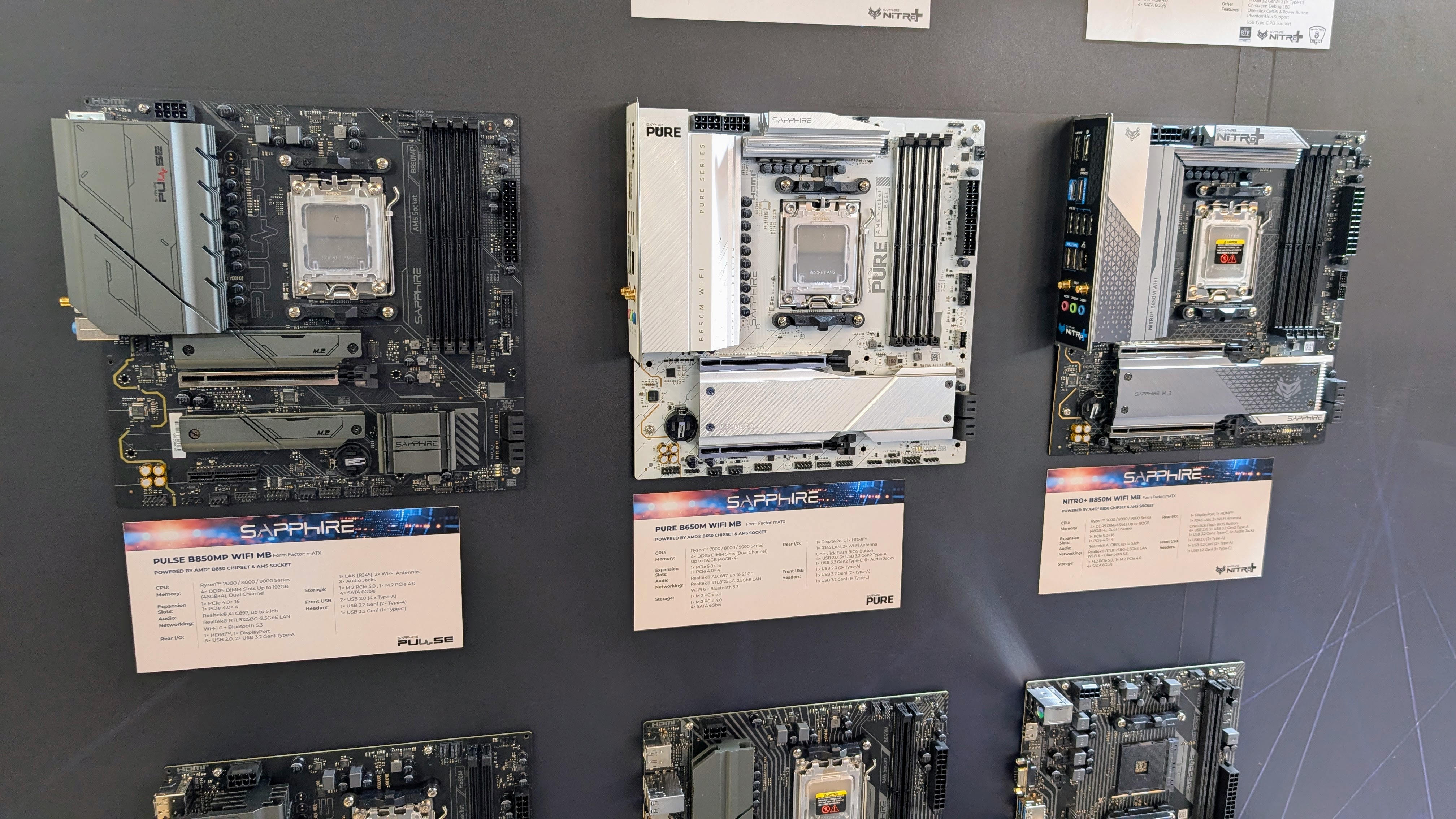 Sapphire motherboards mounted to a wall at Computex 2025