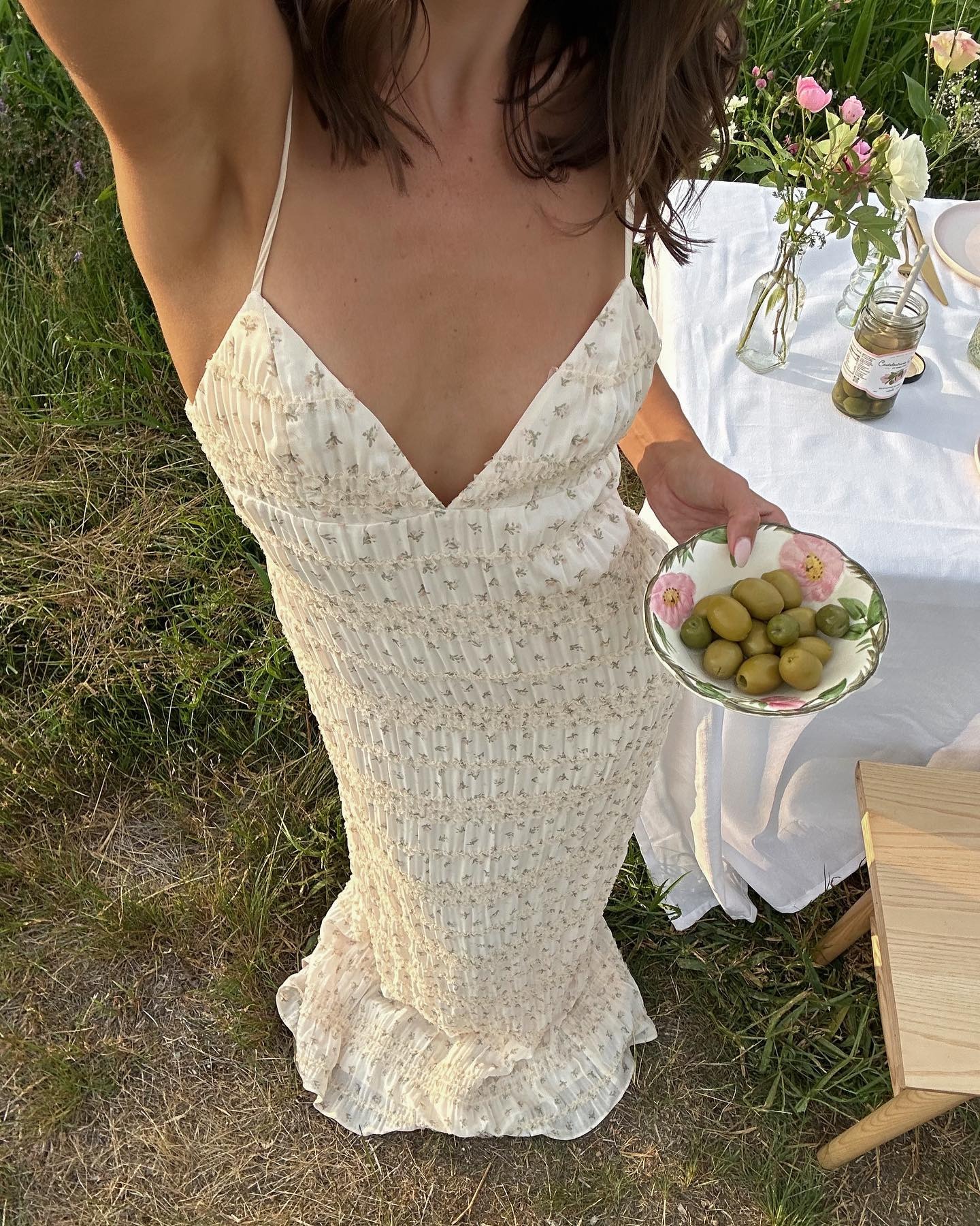 @emmaleger holding a bowl of olives.