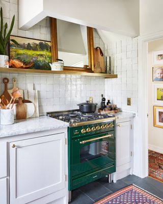 Small rustic kitchen with green shelves and tiles
