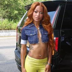 Keke Palmer wearing a denim crop top with a curled hairstyle