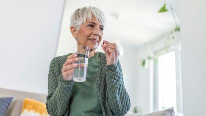 woman taking one of the best vitamins for women over 50