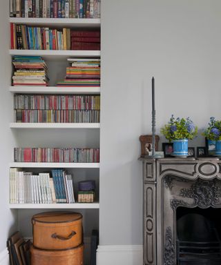 Small living room storage idea showing built in alcove shelving