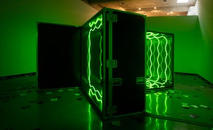 Installation view of a green light impenetrable room