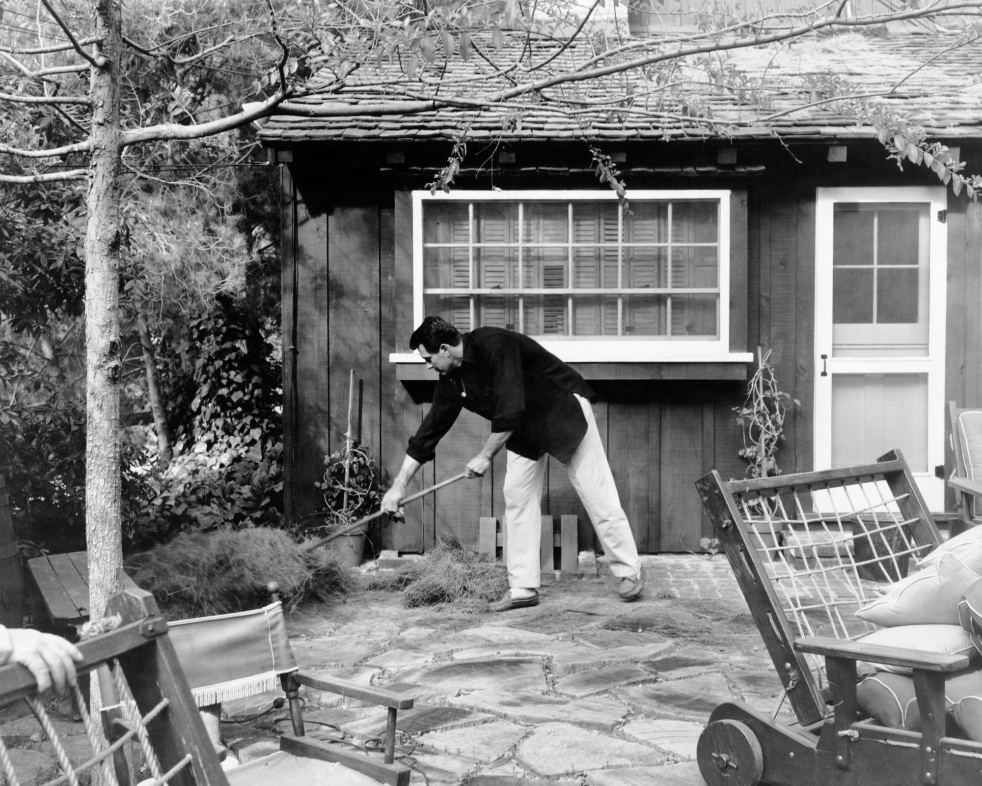rock hudson in his garden outside his house