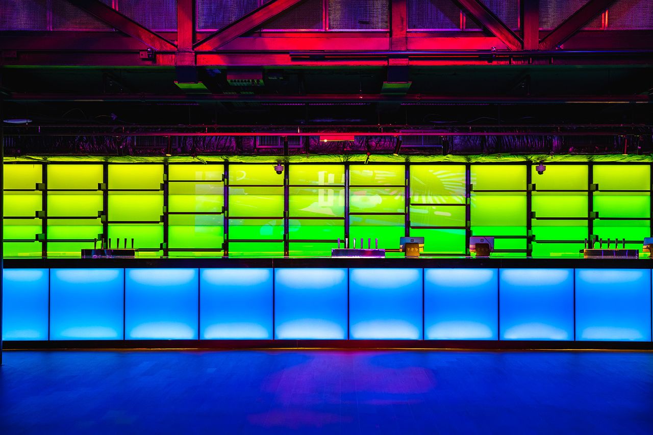 at the outernet event venue in London, bright coloured lighting design animates the bars