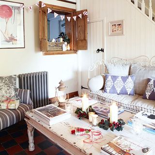 living area with white wall and sofa with cushions