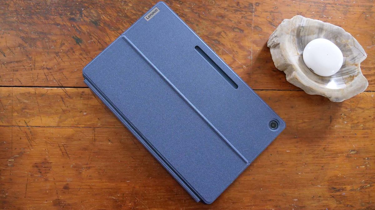 A top-down view of a laptop enclosed in a protective folio case against a wooden surface