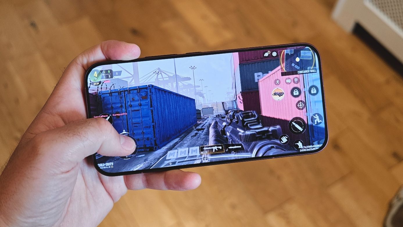 The Poco F9 Ultra being held in the hand and resting on a table